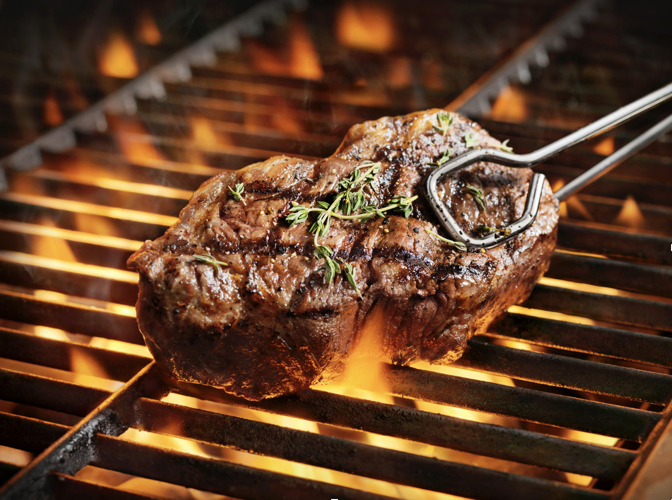 Picture of steak on a grill--for story about AML Compliance and money laundering related to major theft from meatpacking plants