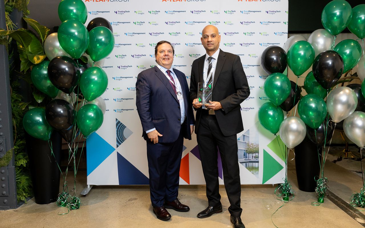 This is an image of two men accepting an award for Best Solution for Digital Transformation in RegTech at the RegTech Insight USA 2024 awards.